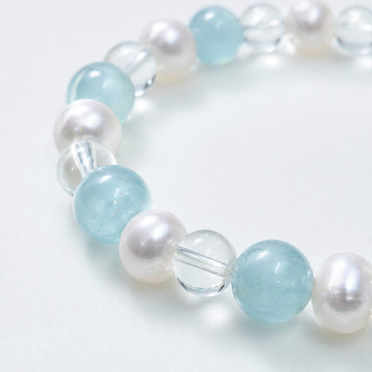 Close-up of clear quartz freshwater pearls and pale blue crystal beads on Veyra Grove bracelet
