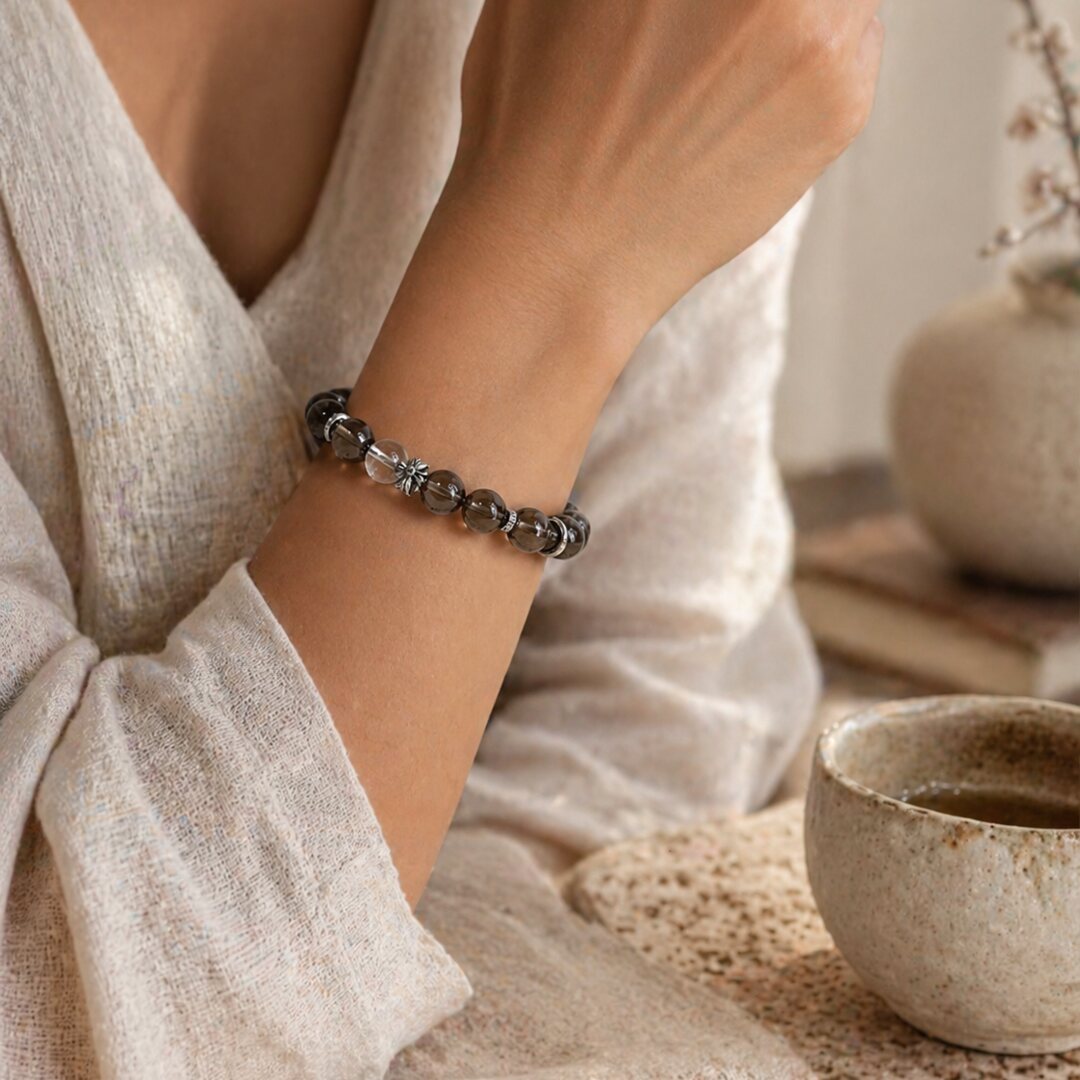 Smoky quartz bracelet worn with soft neutral textures in a calm home setting