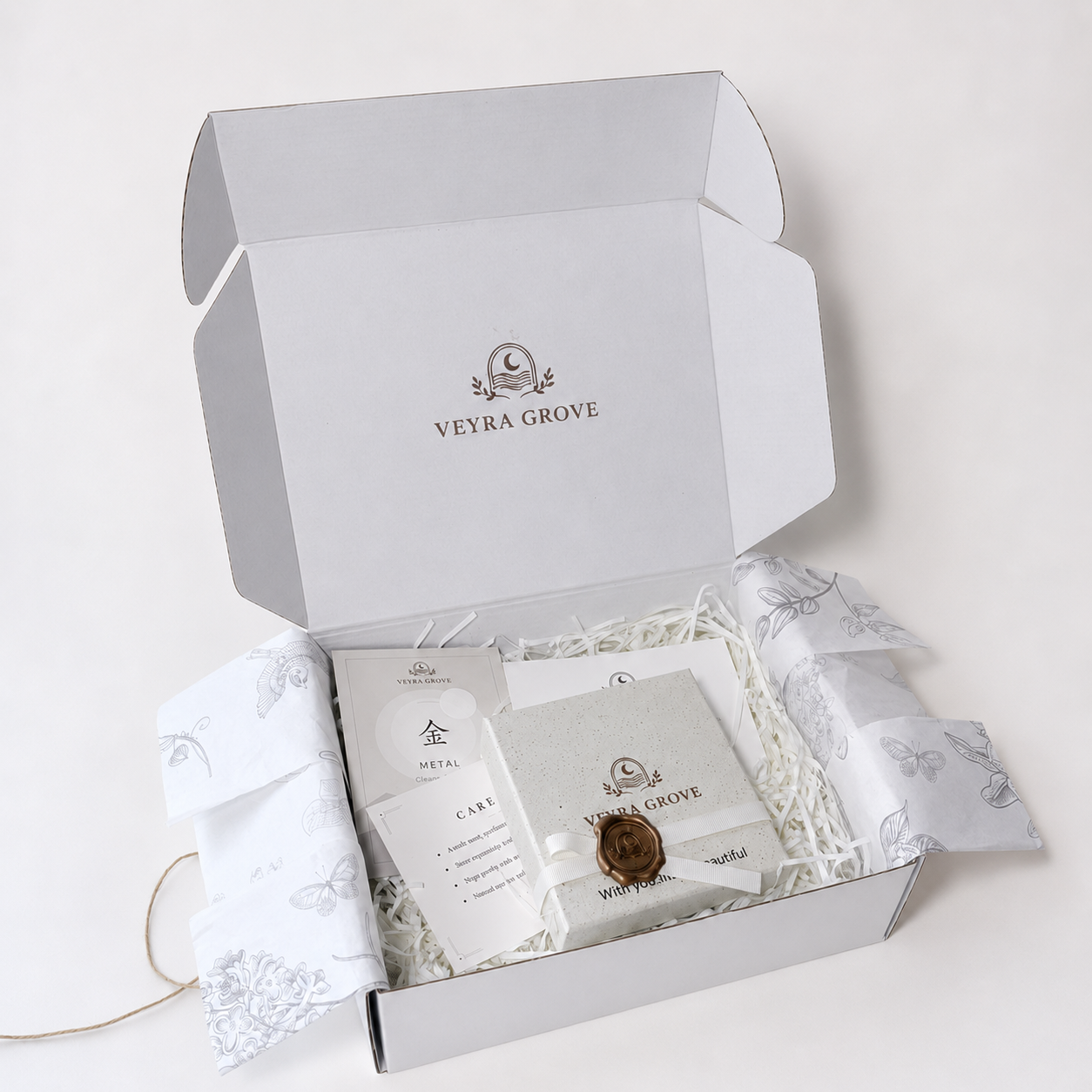 Open Veyra Grove gift-ready packaging with a branded gift box, care card, element card, tissue paper, and protective filler.