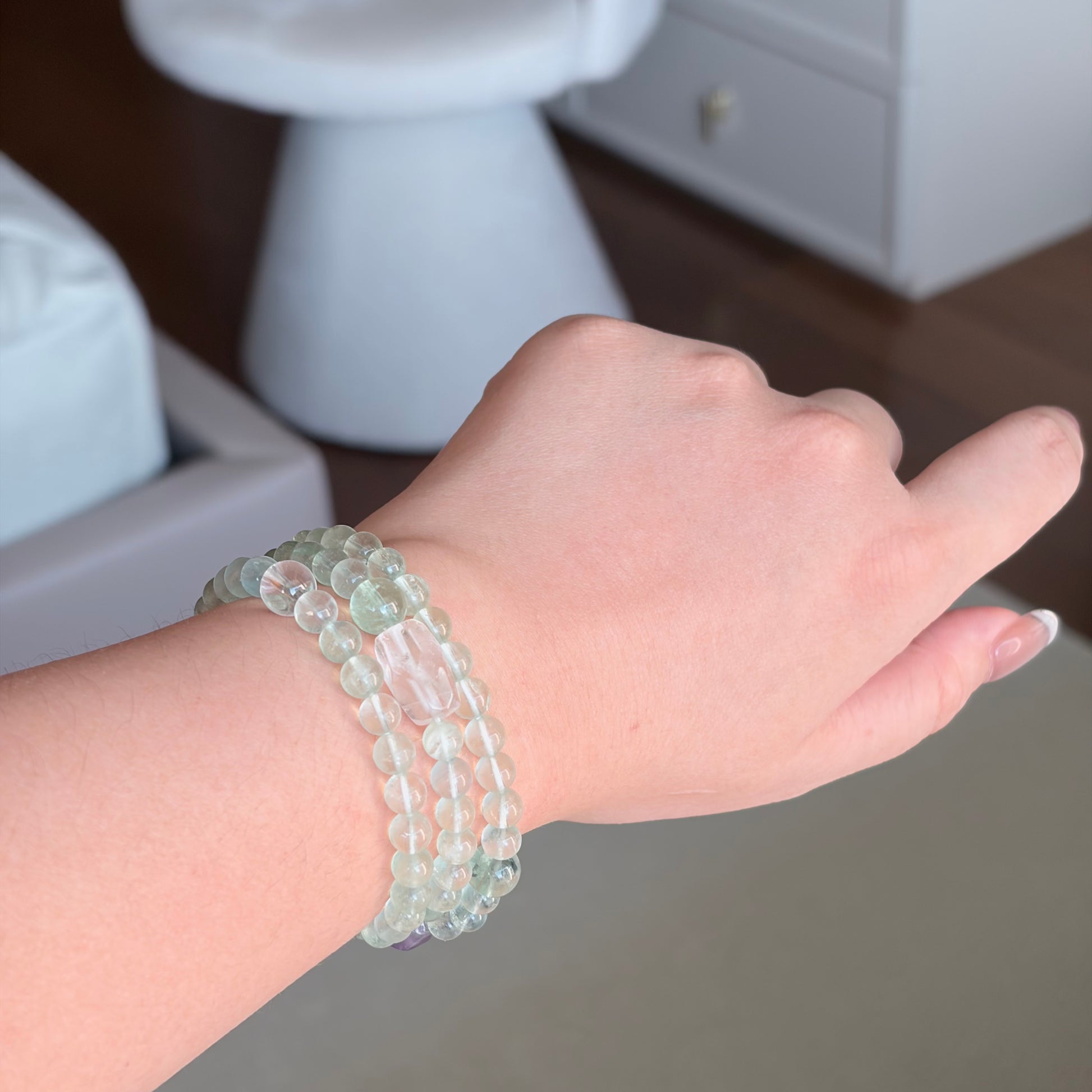 Green Fluorite Amethyst Renewal Wrap Bracelet worn on the wrist, a Wood element multi-wrap bracelet with green fluorite, clear quartz, and amethyst for layered natural styling.