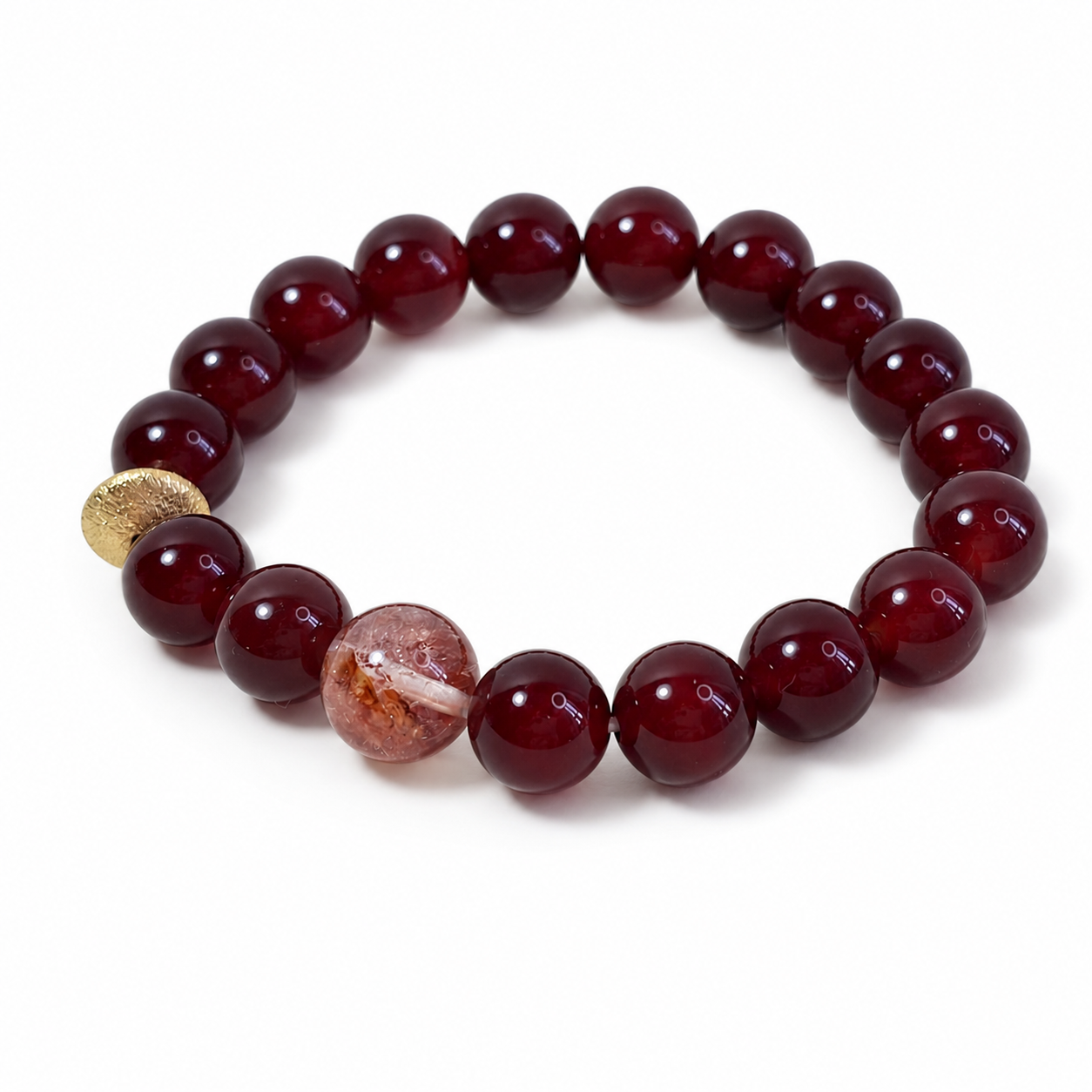 Red agate solar ember bracelet with gold-toned accent bead on white background by Veyra Grove