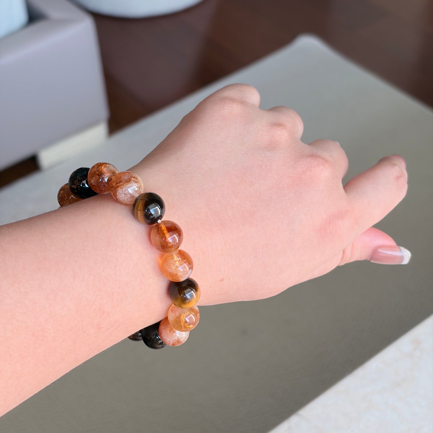 Tiger Eye Smoky Quartz Earth Glow Bracelet worn on the wrist in soft natural light, an Earth element bracelet with tiger eye, smoky quartz, and warm golden-toned beads.