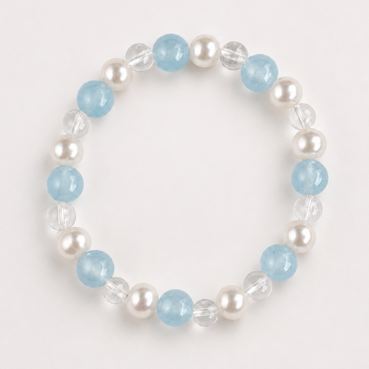 Aquamarine, clear quartz, and freshwater pearl Water bracelet on a soft light gray background.