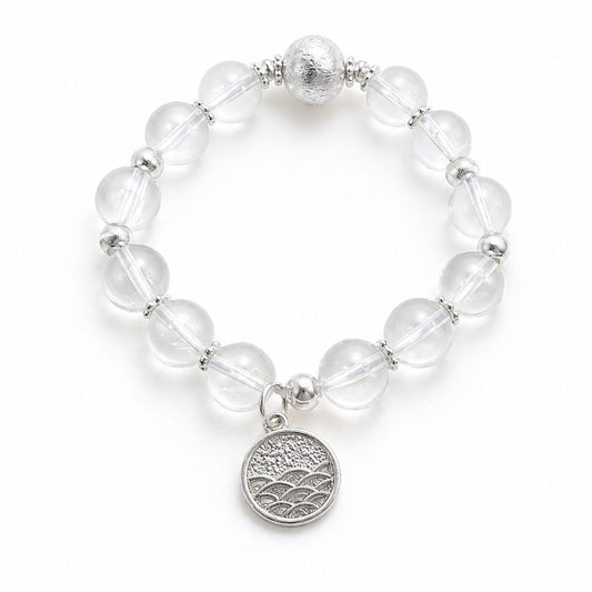 Clear Quartz Moonlit Clarity Bracelet with clear quartz beads and silver-toned charm on white background.