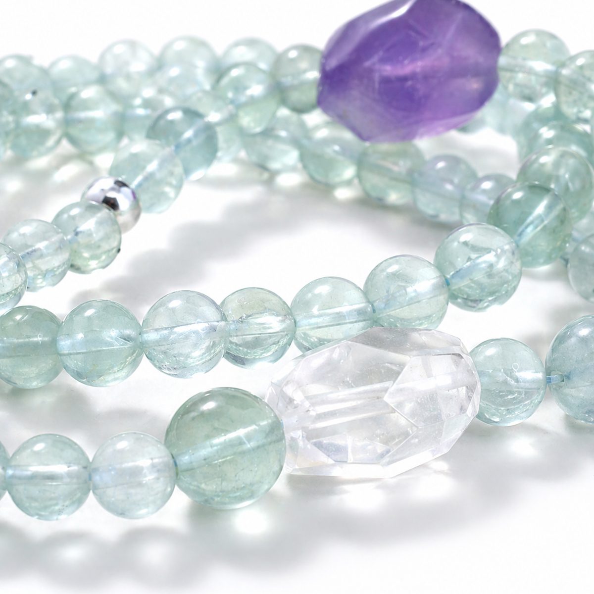 Close-up of green fluorite beads and amethyst accent on Veyra Grove wrap bracelet