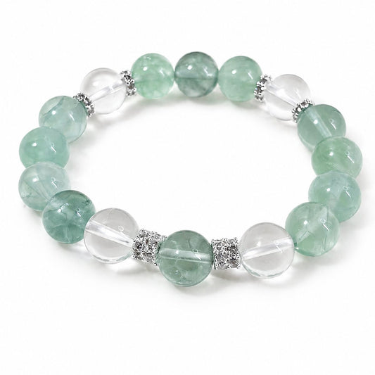 Green fluorite and clear quartz bracelet on white background by Veyra Grove