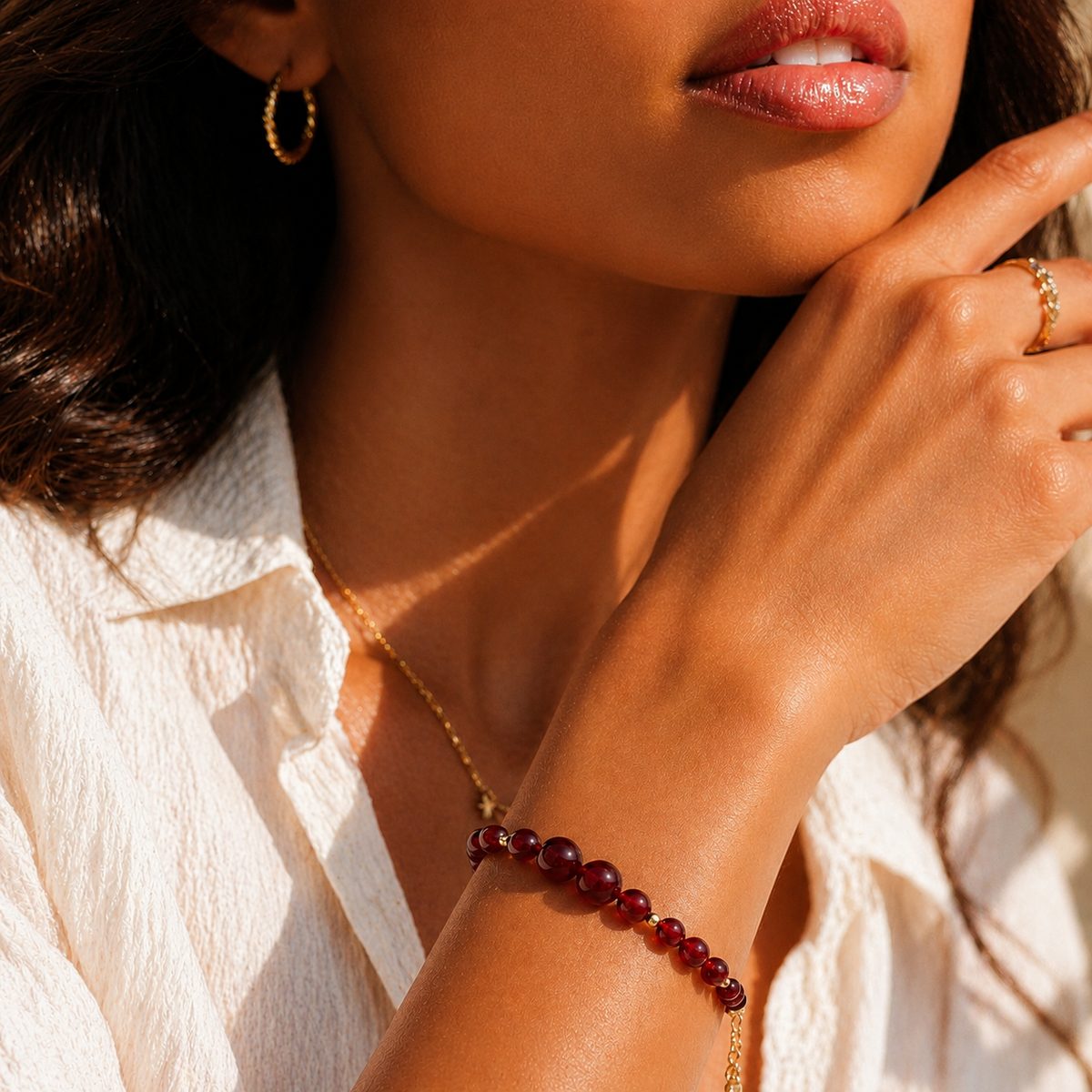 Model wearing Red Agate Ember Line Bracelet in a soft natural light portrait.