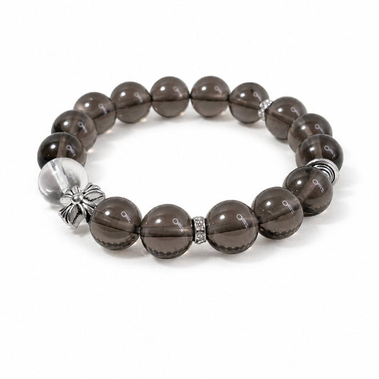 Smoky quartz bracelet with silver-toned floral accent on white background by Veyra Grove