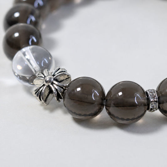 Close-up of smoky quartz beads and silver-toned floral detail on Veyra Grove bracelet